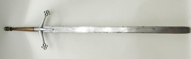 on a plain white surface is a large two-handed sword, one of the sword types