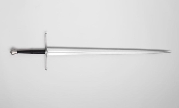 longsword, one of the sword types, laid out on a plain white surface